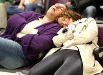 Airline passengers sleep as they wait for flights at Edinburgh airport in Scotland.