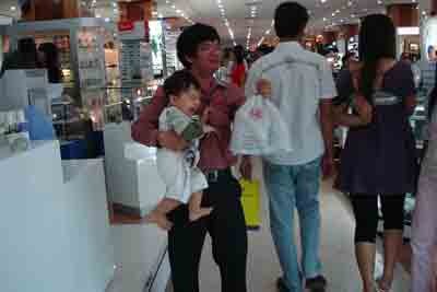A parent with his child in a shopping center in Ho Chi Minh City. Having just the one child is a growing trend in Vietnam's big cities. ( Photo: Dang Quang)