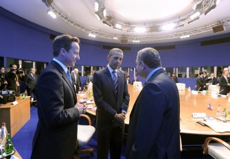 AFP - US President Barack Obama (C) and British Prime Minister David Cameron (L) speak with Egyptian Prime Minister Essam Sharaf before an expanded group G8 Working Session at the International Center of Deauville