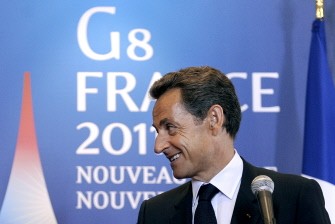 AFP - French President Nicolas Sarkozy smiles as US President Barack Obama (not in picture) makes a statement following their meeting on the sideline of the G8 summit