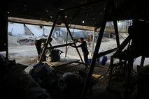 Palestinian men remove sacks of gravel smuggled into the Gaza Strip through a tunnel under the Egypt-Gaza