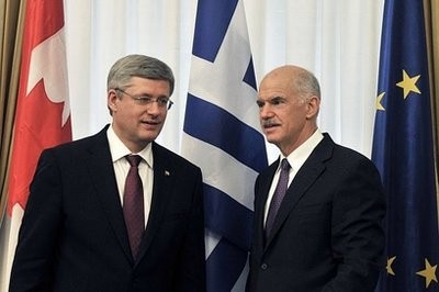 Greek prime Minister George Papandreou (R) talks with visiting Canadian Prime Minister Stephen Harper in Athens