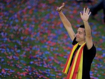 AFP - Barcelona's Xavi Hernandez waves during a celebration with supporters at the Camp Nou stadium in Barcelona on May 29, 2011 a day after the team won the UEFA Champions League