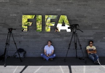 AFP - Media crew wait under a sign of the football's world governing body FIFA at its headquarters on May 29, 2011 in Zurich.