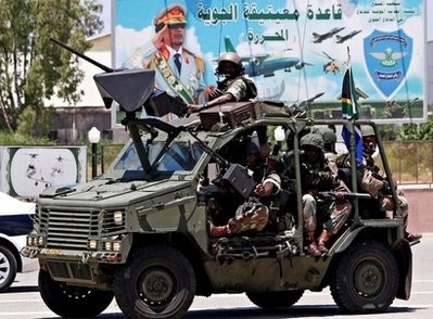 South African army soldiers patrol at Matiga military airport in Tripoli, as part of a security delegation accompanying South African President Jacob Zuma, who held talks on ending the conflict in Libya