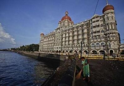 A municipal worker sweeps a pavement in front of the Taj Mahal hotel, one of the sites of the 2008 militant attacks, in Mumbai May 31, 2011