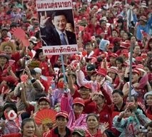 Supporters of exiled Thai former prime minister Thaksin Shinawatra hold placards at a rally in Bangkok