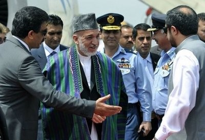 Afghan President Hamid Karzai, centre, meets with Pakistani officials upon his arrival at the Chaklala military airbase in Rawalpindi. Karzai is in Islamabad for a second day of talks.