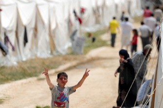 AFP - A Syrian refugee boy flashes a V-sign at the Boynuyogun Turkish Red Crescent camp in the Altinozu district of Hatay, near the Syrian border, on June 12, 2011.
