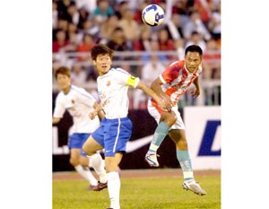 Park Ji Sung is contending fearlessly with a footballer from Navibank Saigon football club for the ball (Photo:Ng.Nhan)