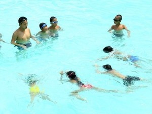 Children being given swimming and rescue lessons