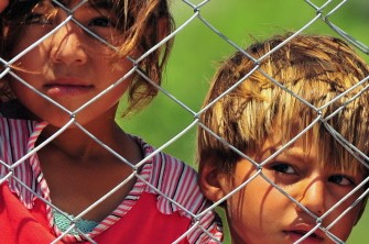 AFP - Syrian refugee children stand behind a fence on June 18, 2011 at the Boynuyogun Turkish Red Crescent camp