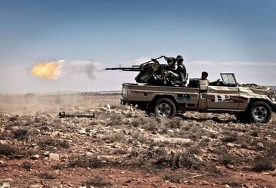 File photo shows Libyan rebels firing a machine gun towards positions held by forces loyal to Moamer Kadhafi in the western Libyan town of Gwalesh