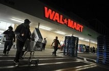Shoppers wheel their purchases out of a Wal-Mart store in Los Angeles, California.