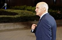 Greek Prime Minister George Papandreou leaves at the end of the first day of a summit of the EU heads