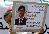 A demonstrator carries a banner during a protest against Syria's President