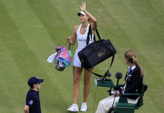 AFP - Maria Sharapova bids farewell to the crowd after defeating German player Sabine Lisicki in a Women's semi-final match at the All England Tennis Club on June 30, 2011.