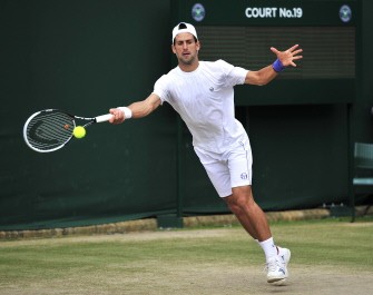 AFP - Novak Djokovic returns the ball during a training on the eve of the men's final against Spanish player Rafael Nadal