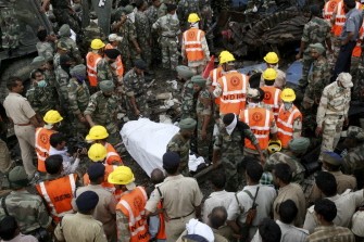 AFP - Indian rescue personnel use a stretcher to carry a body from the scene of a rail accident at Fatehpur on July 11, 2011.