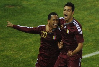 AFP - Venezuelan defender Grenddy Perozo (L) celebrates with forward Nicolas Fedor after scoring the teams's third goal against Paraguay