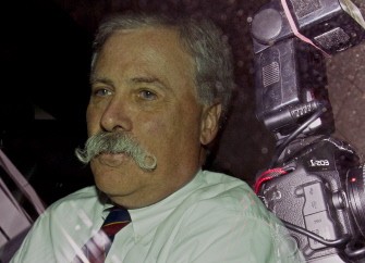 Chase Carey, President, Deputy Chairman and Chief Operating Officer of News Corporation, is pictured through a car window as he leaves News International headquarters in east London, on July 13, 2011.
