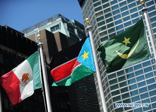 The national flag (C) of South Sudan is hoisted after South Sudan is admitted to membership in the United Nations at the UN headquarters compound in New York, the United States, July 14, 2011