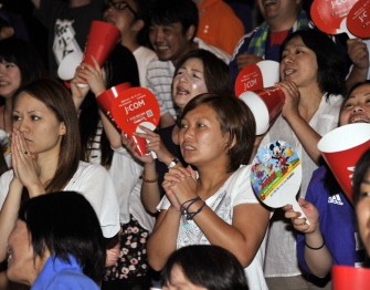 AFP - Supporters of the Japanese women's football team react during the women's World Cup football championship game against the US during a public viewing at Yamato city, suburban Tokyo on July 18, 2011.