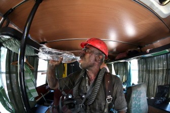 AFP - A rescuer drinks water as he rests at Sukhodolskaya-Vostochnaya coal mine in Lugansk region on July 29, 2011.