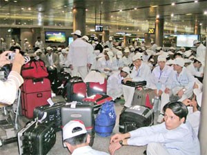 Vietnamese laborers wait for their flight at HCMC’s Tan Son Nhat Airport