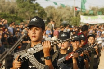 New graduates of a Palestinian Hamas military camp, ages 12-18, perform mock exercises during a graduation ceremony in Gaza City, on July 29, 2011.