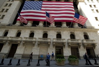 AFP - Traders take breaks outside the New York Stock Exchange August 3, 2011 in New York