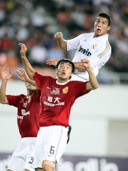 AFP - Real Madrid's Cristiano Ronaldo (R) heads the ball during the pre-season friendly football match against Guangzhou Evergrande