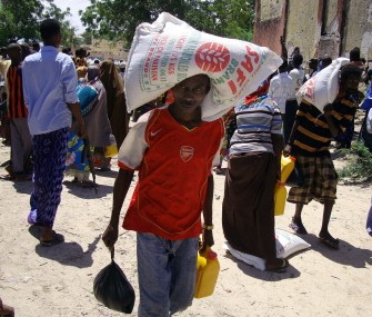 Displaced Somalis receive food aid distributed by Muslim Aid organization at a camp in southern Mogadishu’s Bermuda neighbourhood on August 4, 2011.