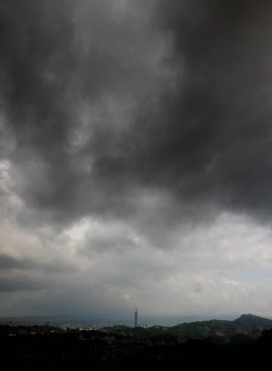 Dark clouds gather above Taipei on August 6, 2011 as typhoon Muifa passes eastern Taiwan on a heading to make landfall on China's east coast.