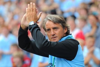 AFP - Manchester City's Italian manager Roberto Mancini applauds the fans at a training session at The City of Manchester stadium on August 3, 2011.