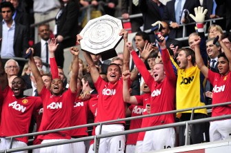 AFP - Manchester United's Serbian player Nemanja Vidic (3rd L) lifts the trophy after winning the match