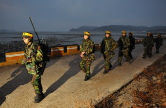 In a file picture taken on December 19, 2010 South Korean marines patrol on Yeonpyeong island in the disputed waters of the Yellow Sea. South Korea's navy fired shots on August 10, 2011