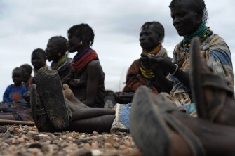 Turkana women sit as they eat wild fruits in Kalokutanyang in northwest Turkana, on August 9, 2011