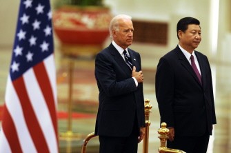 AFP - US Vice President Joe Biden (L) listens to the US national anthem with Chinese Vice President Xi Jinping (R) during a welcome ceremony in the Great Hall of the People in Beijing on August 18, 2011
