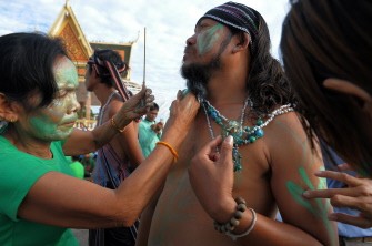 AFP - A Cambodian villager paints the body of another to resemble the forest people during a rally against the destruction of the Prey Lang forest in front of the Royal Palace in Phnom Penh on August 18, 2011