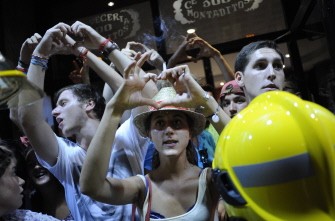 AFP - Pilgrims react while protesters march in central Madrid late August 19, 2011 against a visit by Pope Benedict XVI and police violence