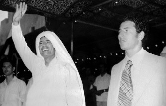 AFP - (FILES) A picture taken in June 1975 shows Libyan leader Moamer Kadhafi (L) waving at the crowd in Tripoli as he walks with Abdessalam Jalloud