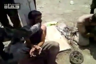 An image grab taken from a video uploaded on YouTube on August 19, 2011 shows a member of the Syrian security forces kicking an arrested man in the face in the central city of Hama during military operations.