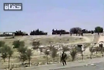 An image grab taken from a video uploaded on YouTube on August 19, 2011 shows Syrian security forces taking position in the central city of Hama during military operations