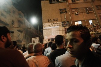 Libyans watch Al Jazeera arabic live channel as tens of thousands celebrate what the rebels claim to be the first uprising in Tripoli against the Kadhafi's regime on August 21, 2011