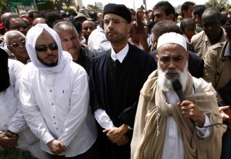 AFP file -- A May 2, 2011 file photo shows Mohammed (L) and Saif al-Islam Kadhafi (2nd L), sons of Libyan leader Moamer Kadhafi, attend the funeral of their brother Seif al-Arab at the Al-Hani cemetery in Tripoli after the 29-year-old was killed along with three of the leader's grandchildren in a NATO airstrike early on May 1