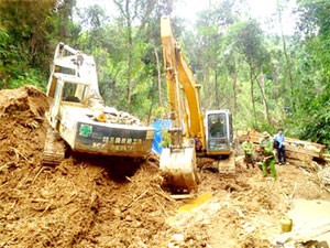 Local officials in Dak Nong Province check a gold ground being excavated illegally by local Thanh Trung Company