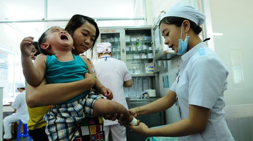 A boy cries while taking a medical examination at a HCMC-based hospital