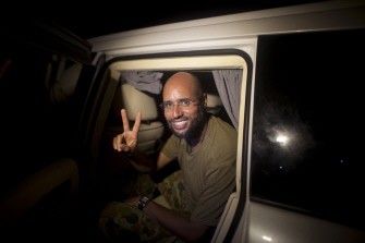 AFP- Saif al-Islam Kadhafi, son of Libyan leader Moamer Kadhafi, flashes the V-sign for victory as he appears in front of supporters and journalists in the Libyan capital Tripoli in the early hours of August 23, 2011