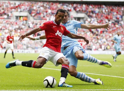 Tiền vệ Nani (trái, Man.United) trước pha truy cản quyết liệt của hậu vệ Kolarov (Man.City).